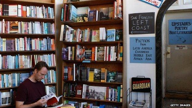 A man reads a book in City Lights