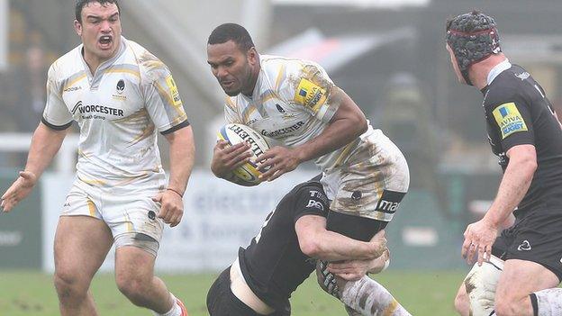 Josh Drauniniu is stopped by a Newcastle defender.