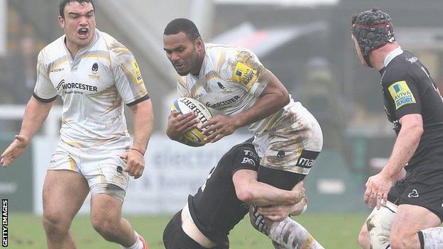 Josh Drauniniu is stopped by a Newcastle defender.