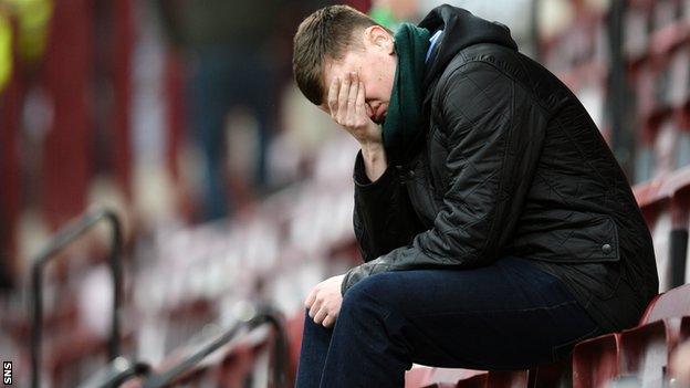 A Hibs fan looks dejected