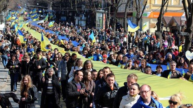 Pro-European supporters hold a large Ukrainian flag during a rally in Odessa, Ukraine, on 30 March 2014