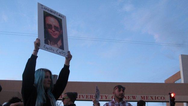 Protesters hold a rally in front of the University of New Mexico in Albuquerque against recent police shootings on 30 March 2014