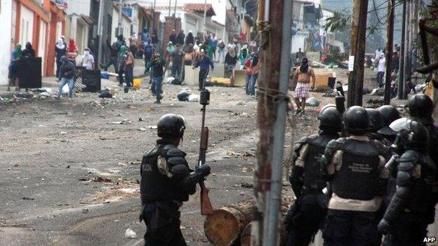 Riot police stand by during a protest against Venezuelan President Nicolas Maduro in San Cristobal on 28 March, 2014