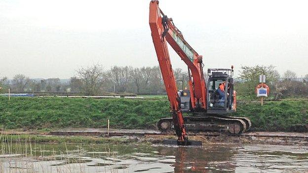 Dredging equipment beside a Somerset river