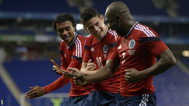 Colombia's Juan Cuadrado (left), James Rodriguez (centre) and Pablo Armero celebrate