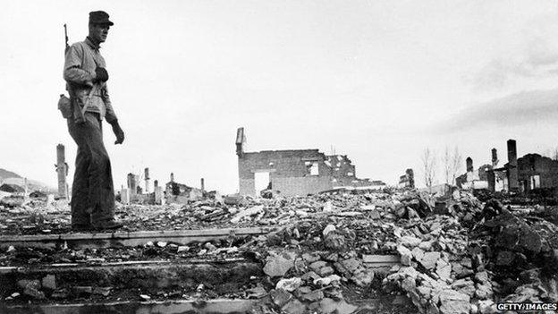 US soldier stands among rubble in Korean city of Hamhung