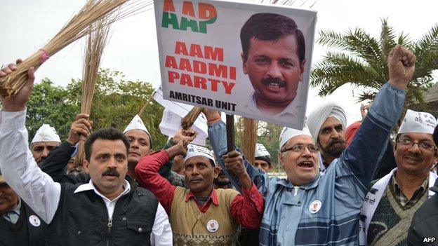 Aam Aadmi Party activists hold brooms as they shout-slogans during protest against the corrupt political system in Amritsar on February 15, 2014