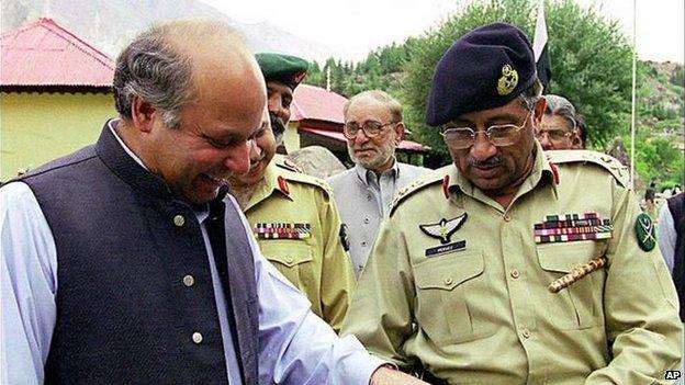 Prime Minister Nawaz Sharif, left, and Gen. Pervez Musharraf look at light machine gun captured from Indian soldiers during Kargil crisis in this undated file photo in Kashmir. 11/11/1999