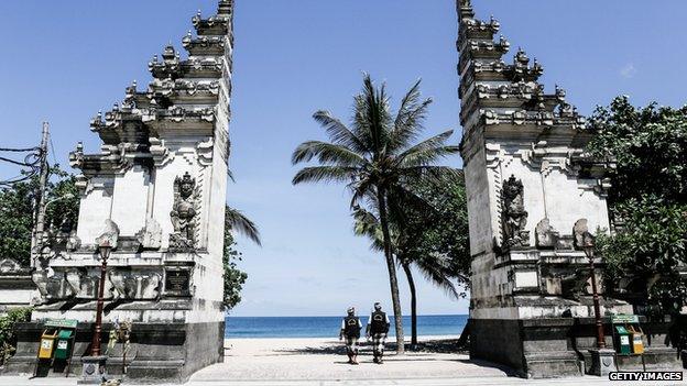 An empty street patrolled by traditional guards on Nyepi in Bali