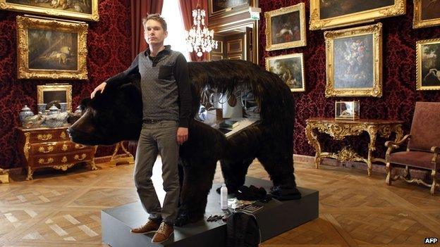 Abraham Poincheval beside his bear at the Hunting and Wildlife Museum in Paris