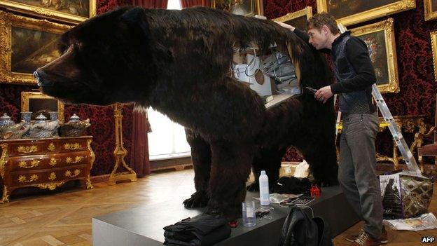 Abraham Poincheval beside his bear at the Hunting and Wildlife Museum in Paris