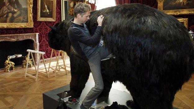 Abraham Poincheval climbs inside his bear at the Hunting and Wildlife Museum in Paris