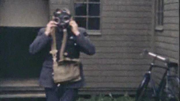 An RAF serviceman tries on a gas mask at RAF Aldergrove circa 1940