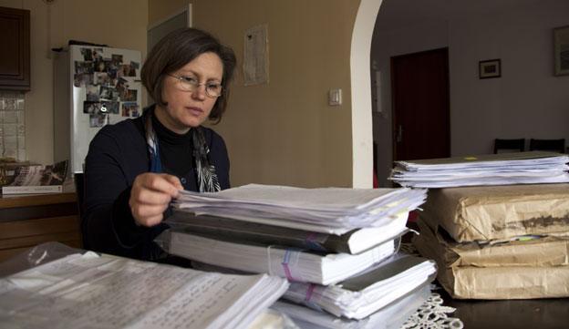 Carmen reading the files made about her family