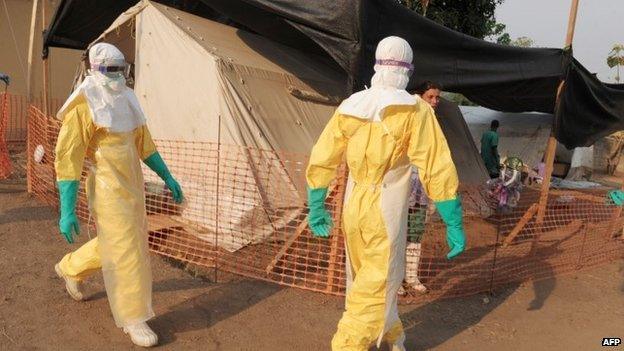 Health specialists work in an isolation ward for patients in southern Guinea. Photo: 1 April 2014