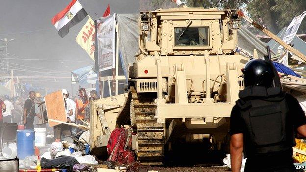 Security forces clear pro-Morsi protesters from a square near Cairo's Rabba al-Adawiya mosque on 14 August 2014