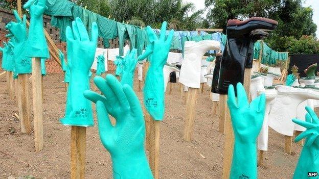 View of gloves and boots used by medical staff, drying in the sun, at a centre for victims of the Ebola virus in Guekedou, on 1 April 2014