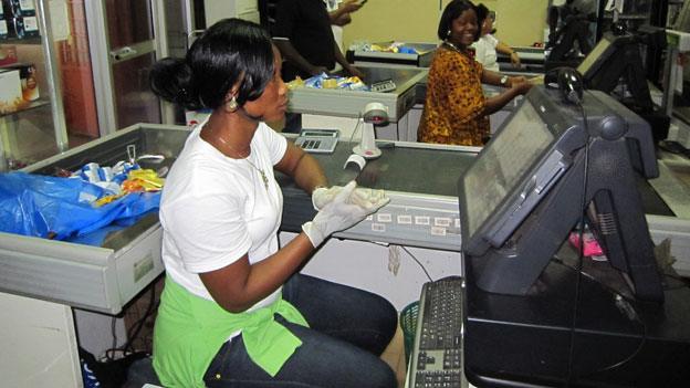 Supermarket checkout staff wearing gloves in Liberia