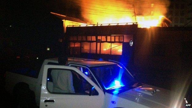 A man stares at a restaurant by the sea shore burning after a powerful earthquake hit Chile's Pacific coast