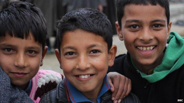 Children pose for a photo on the streets of Kashmir