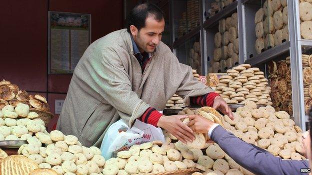 A man sells bread from his stall in Bijbehara, Kashmir