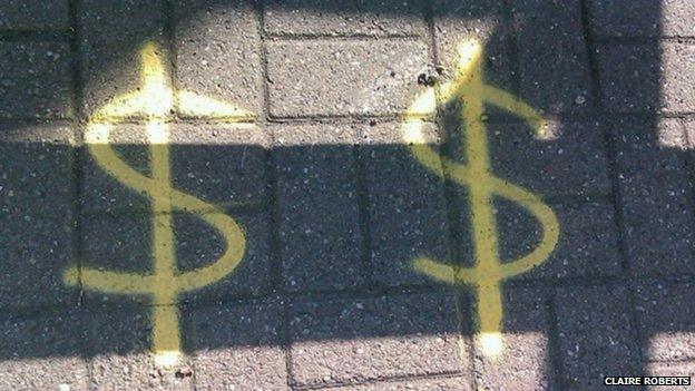 dollar signs on the road