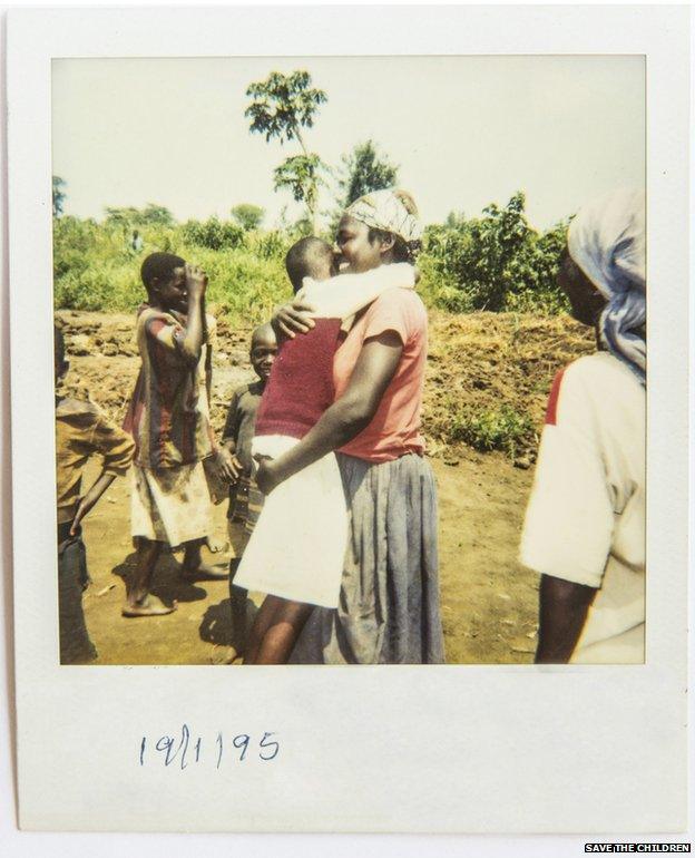 A Polaroid photo of the moment of reunification between separated children and their family.