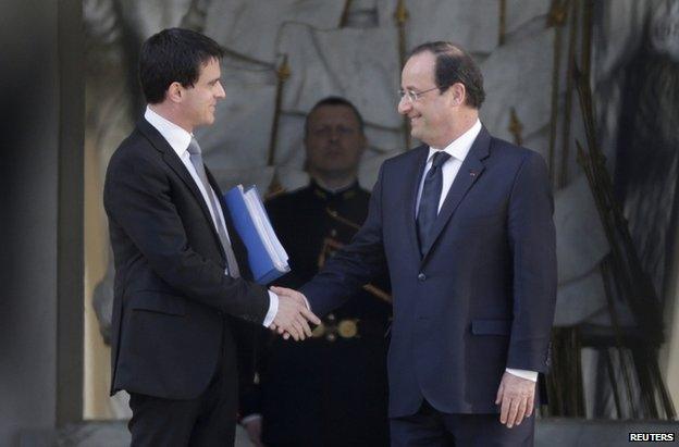 New Prime Minister Manuel Valls (left) shakes hands with President Francois Hollande outside the Elysee Palace in Paris, 2 April