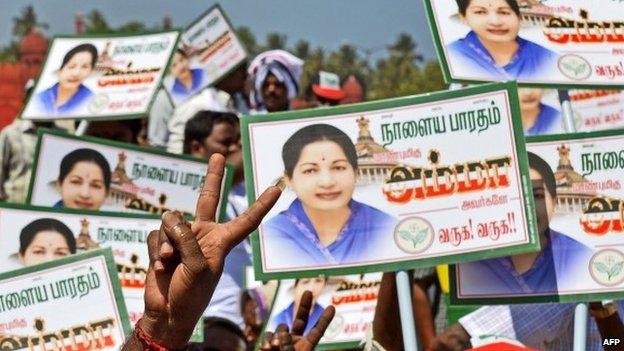 Supporters of J Jayalalithaa wave placards ahead of a public meeting in Pondicherry on March 27, 2014