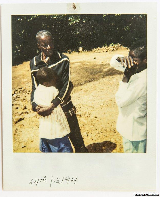 A Polaroid photo of the moment of reunification between separated children and their family.