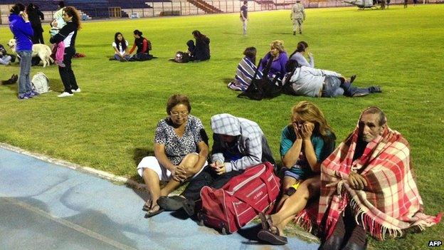 Locals take refuge at the city stadium in Iquique, Chile, on 1 April 2014