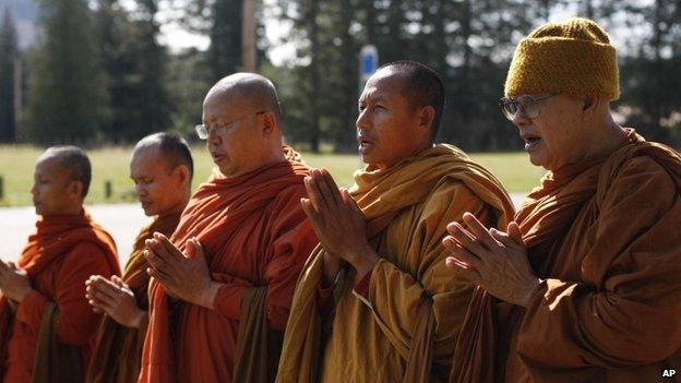Buddhist monks, from the Atammayatarama Buddhist Monastery in Woodinville, chant for the victims of a deadly mudslide near a west side road block in Oso, Washington 1 April 2014