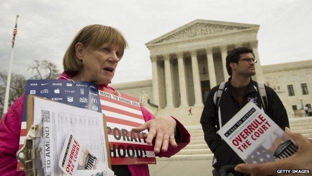 Joan Stallard (left) of Washington DC talks in front of the US Supreme Court in Washington DC 2 April 2014