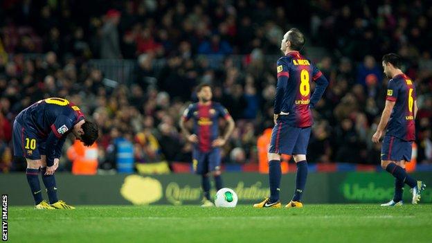 Lionel Messi (L) of Barcelona stands with Andres Iniesta, ready to resume the game, after conceding their third goal during the Copa del Rey semi final second leg match.