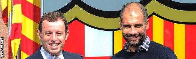 Barcelona's coach Josep Guardiola (R) shakes hands with Barcelona's Sandro Rosell (L) on February 23, 2011 at Camp Nou stadium in Barcelona after signing his one-year contract extension.