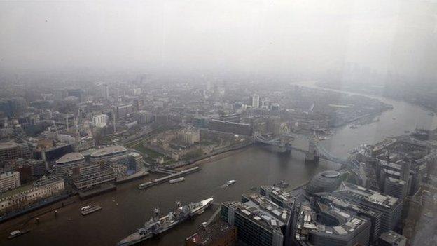 The Thames and Tower Bridge in London under thick smog