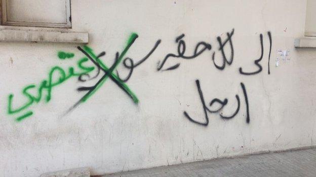 Graffiti on a wall in Lebanon reading, "To every despicable Syrian, leave". Activists crossed out the word "Syrian" and instead wrote "racist".