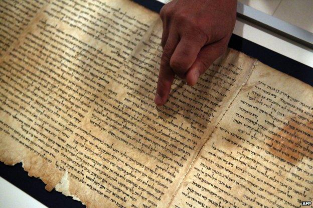 Dr. Adolfo Roitman, curator of the Dead Sea Scrolls and head of the Shrine of the Book points at the original Isaiah scroll found in Qumaran caves in the Judean Desert