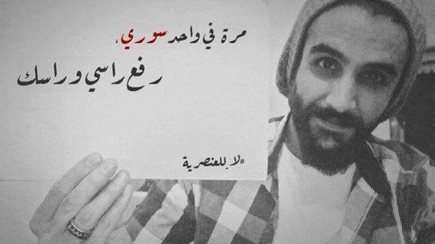 Lebanese activist Salam Kabboul in a photos with a placard reading in Arabic: "I once met a Syrian who made us both proud"