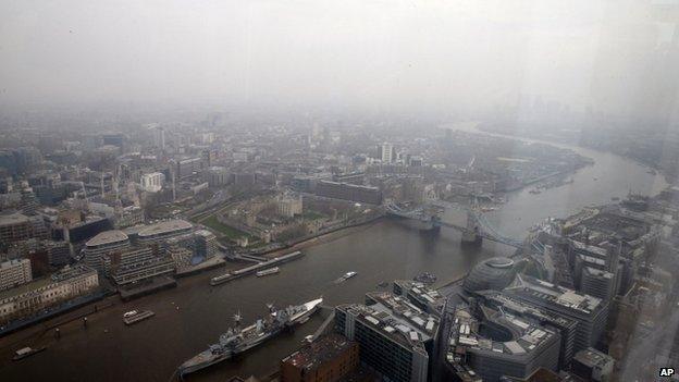 The Thames and Tower Bridge in London under thick smog