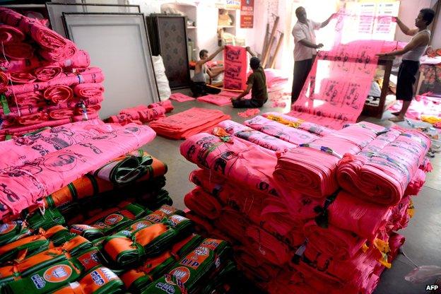Indian workers make different party campaign flags at a workshop in Hyderabad on 7 March 2014