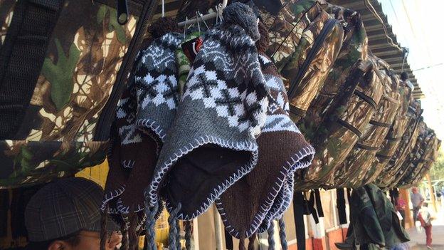 Rucksacks and woolly hats at an outdoor goods store in Altar, Mexico