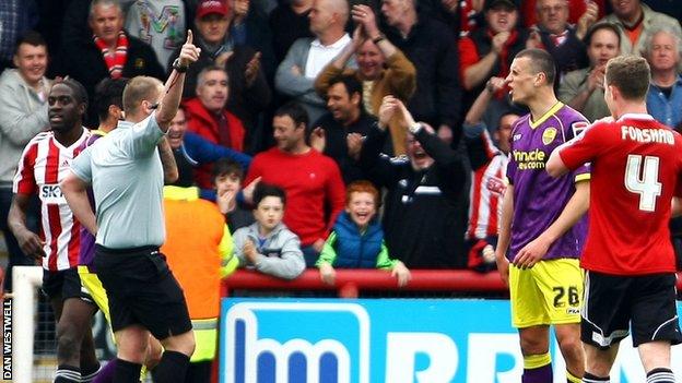 Referee Charles Breakspear sends off Notts County defender Haydn Hollis