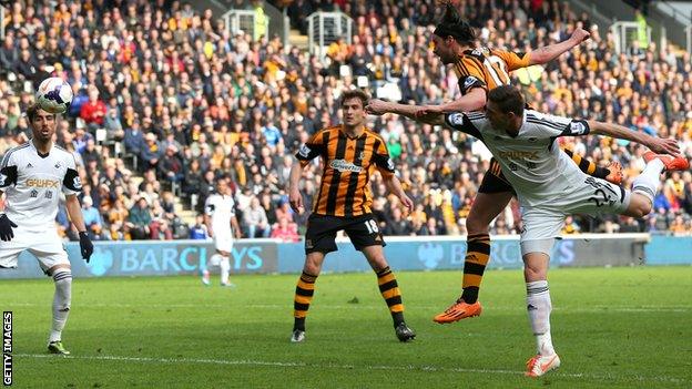 George Boyd of Hull City rises above Angel Rangel of Swansea to score the opening goal.