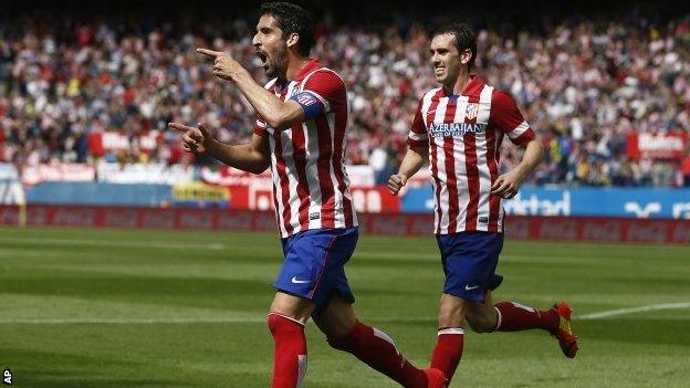 Atletico Madrid's Raul Garcia (left)