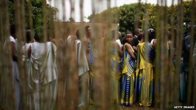 Dressed in traditional gowns, women line up before marching to commemorate the genocide of 1994 at the Kicukiro College of Technology football pitch on 5 April 2014 in Kigali, Rwanda.