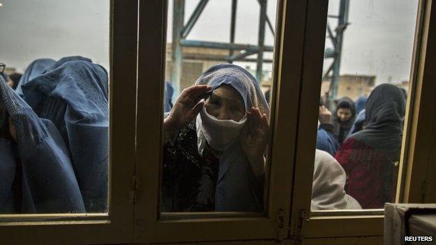 Afghan women wait for their turn to vote at a polling station in Mazar-i-Sharif