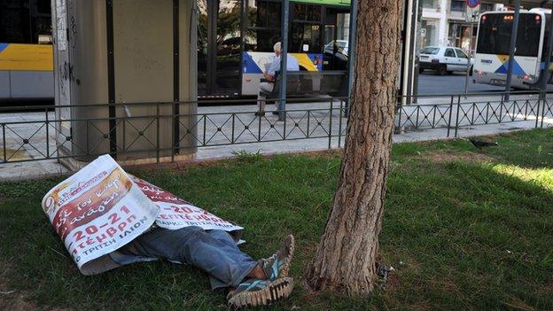 Homeless man sleeping in an Athens park - file pic