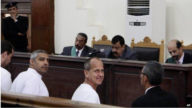 Baher Mohamed (left), Mohamed Adel Fahmy (second left), and Peter Greste