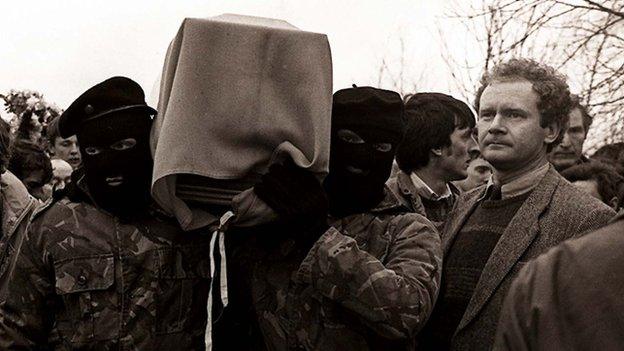 Martin McGuinness pictured with masked men at an IRA funeral in 1988